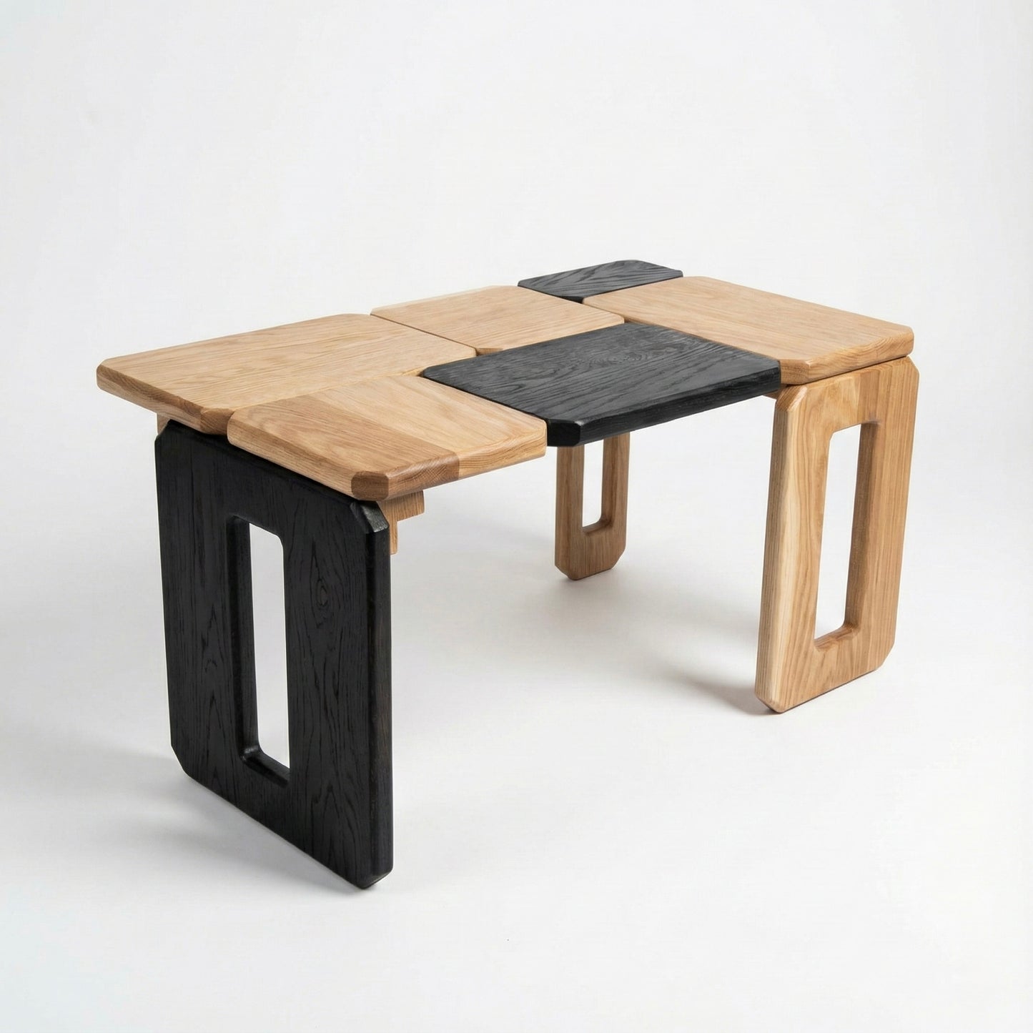 Modular wooden table with black accents on a white background