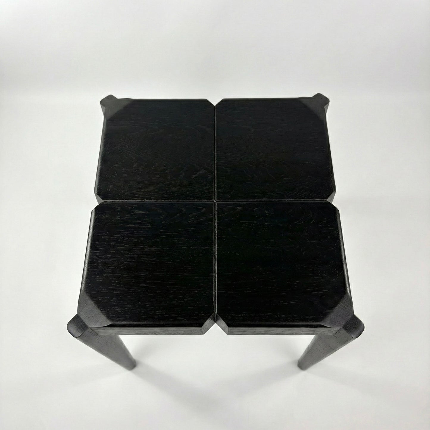 Black geometric stool on a white background
