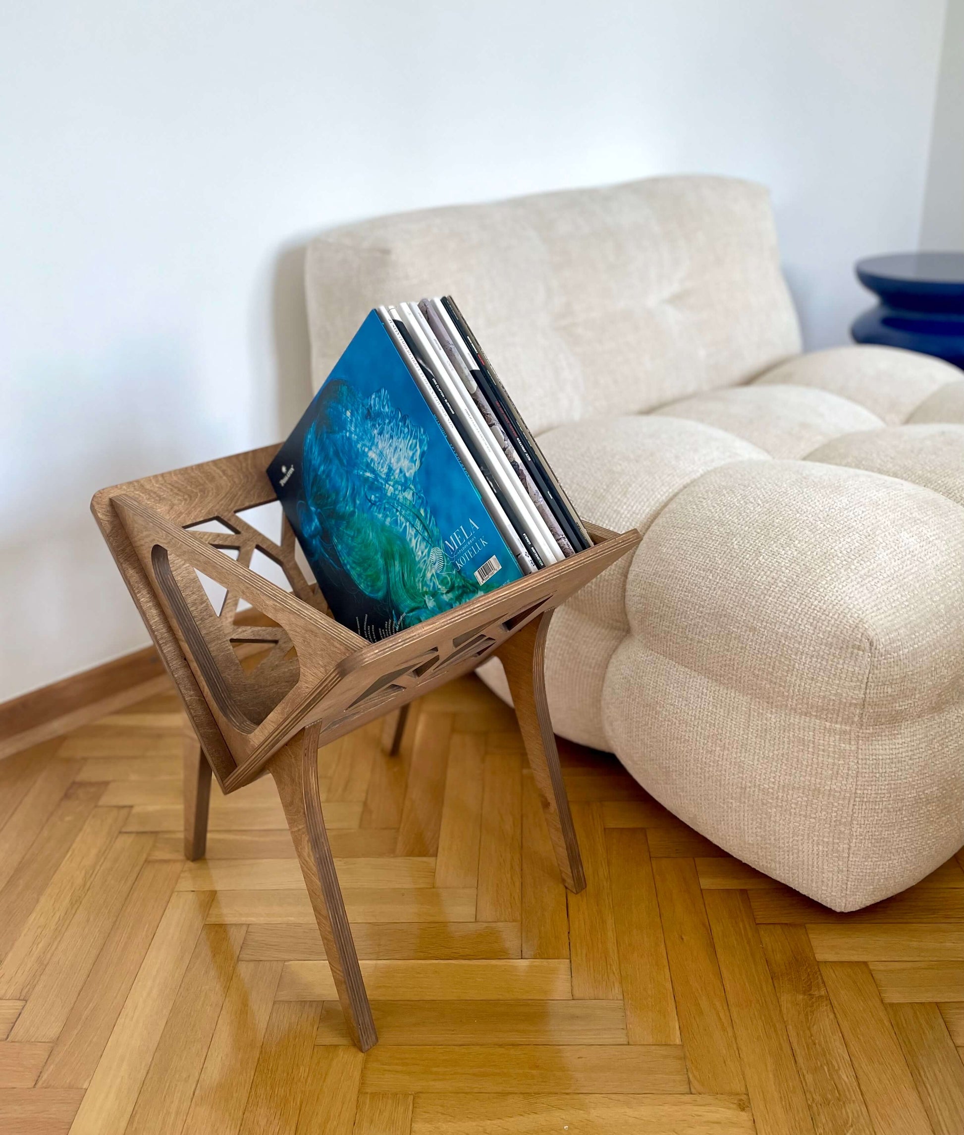 Side view of Small Thor vinyl stand displaying its open storage compartment in a midcentury interior