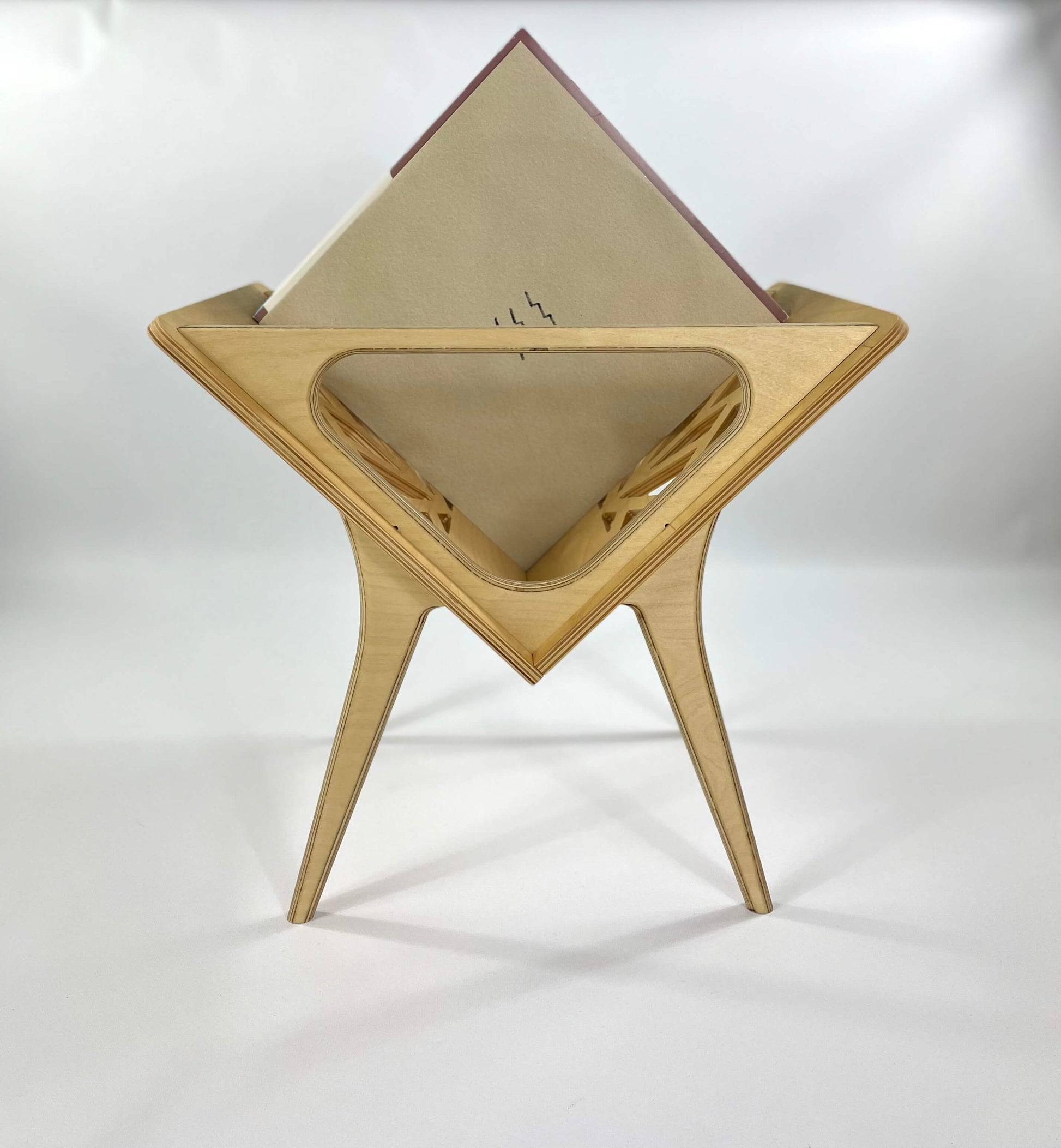Side view of Small Thor vinyl stand  in natural beech finish highlighting its geometric cutout design