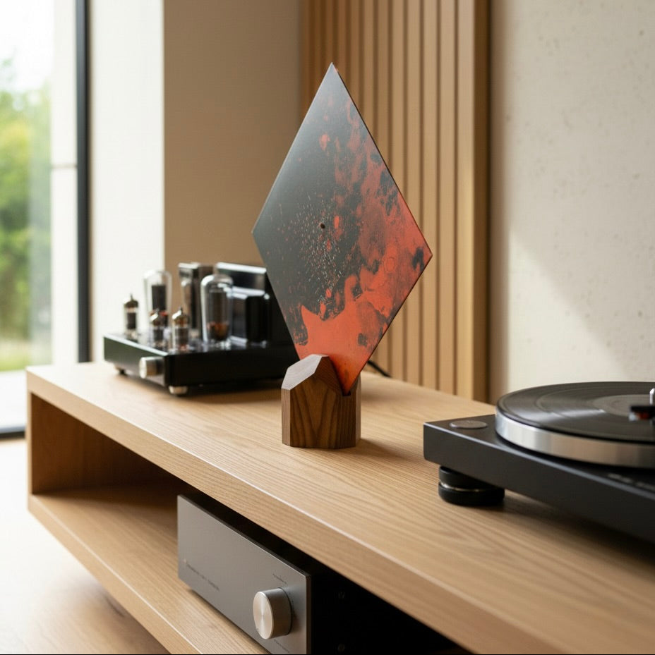Turntable setup on a wooden surface with a decorative now playing stand and window in the background
