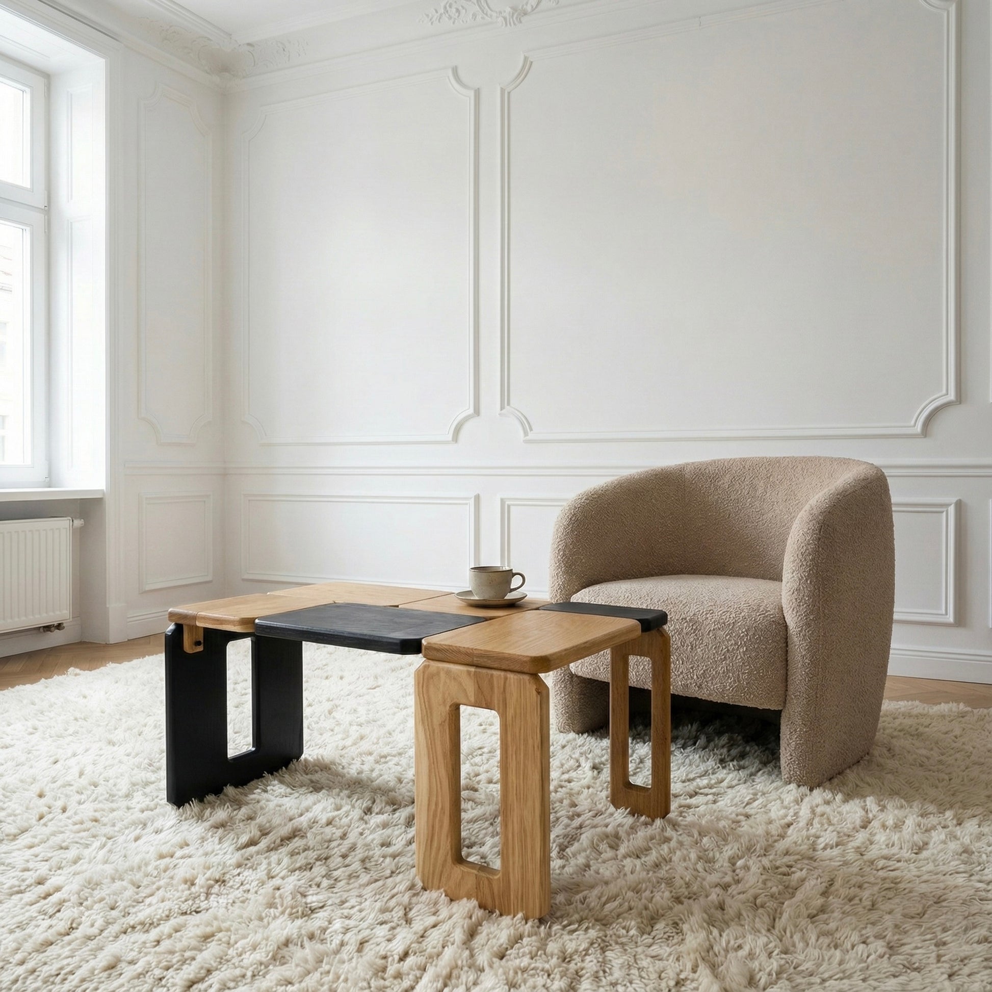 Modern living room with a beige armchair and wooden coffee table.
