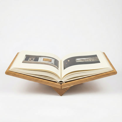 Open book on a wooden stand with images inside, on a white background