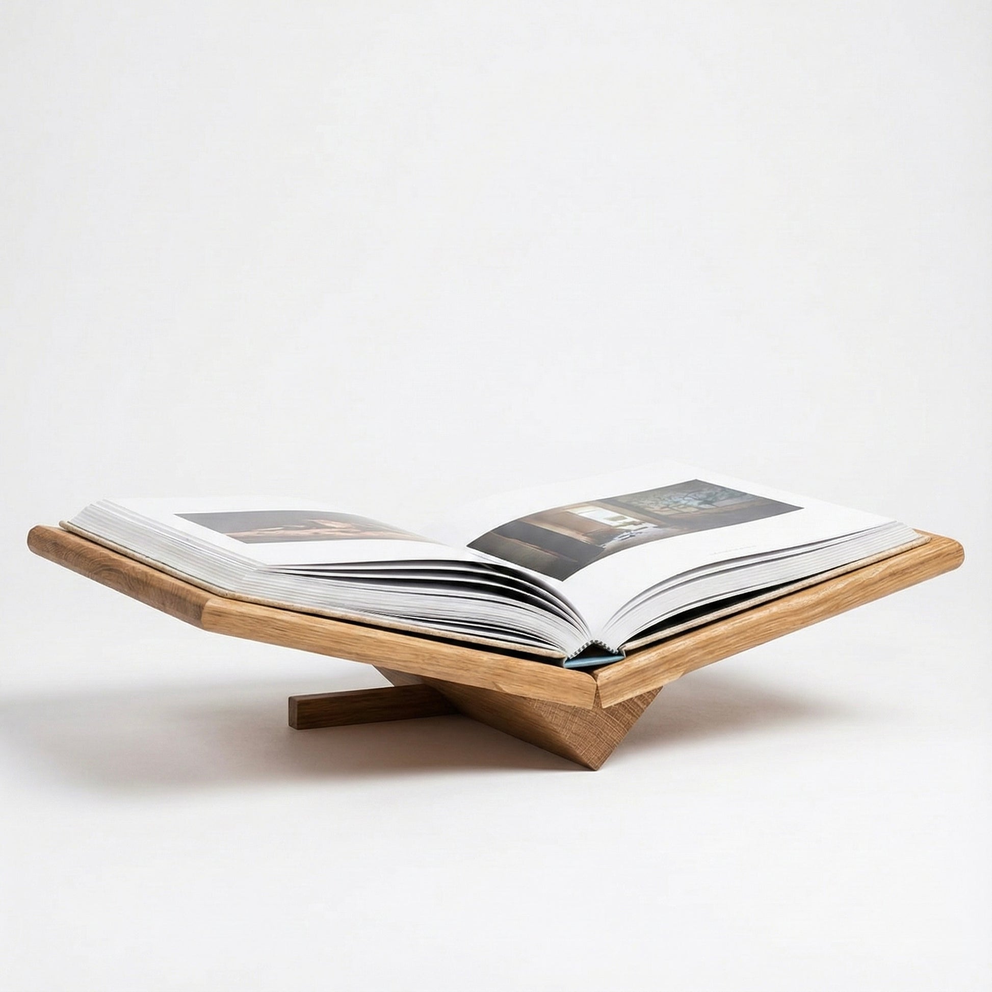 Wooden book stand holding an open book on a white background