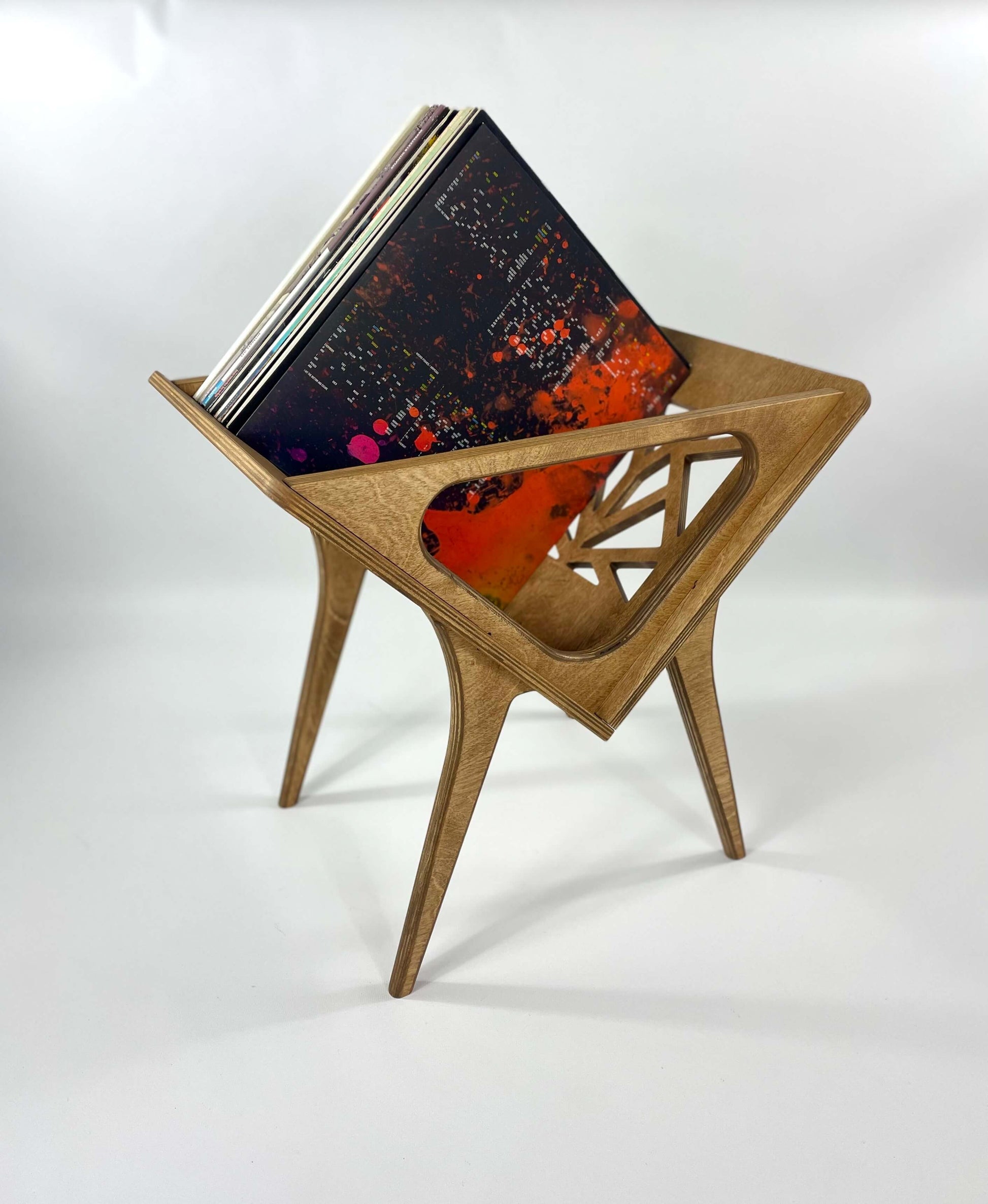 Side view of Small Thor vinyl stand in warm walnut finish, highlighting its geometric cutout design