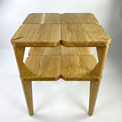 Wooden bedside table with two square shelves on a white background