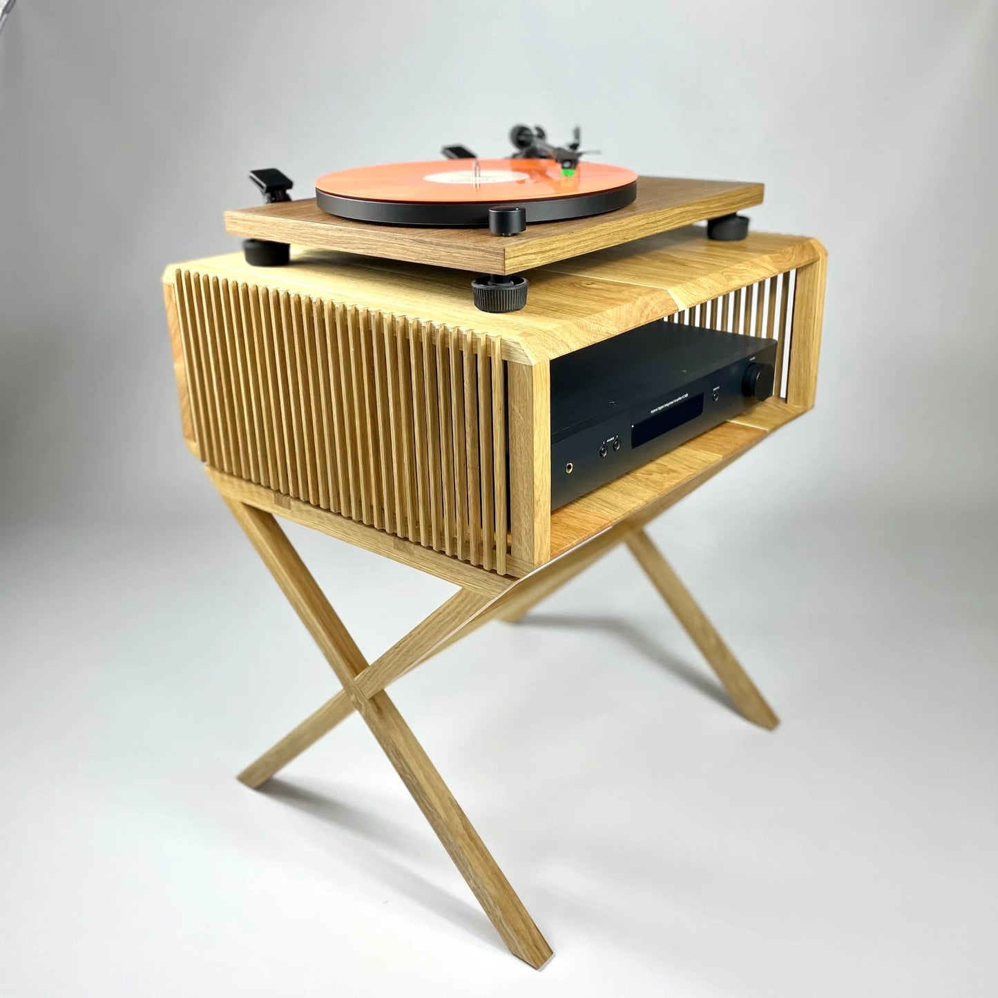 Wooden record player stand with turntable on a gray background