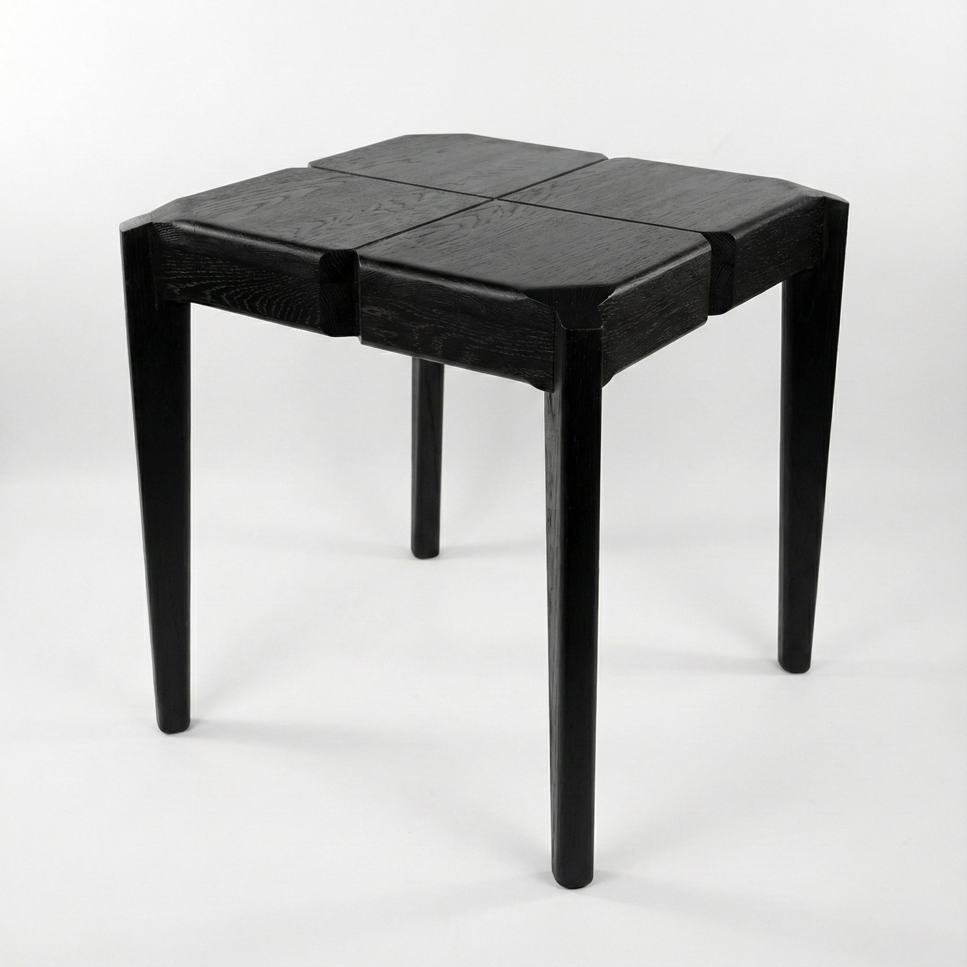Black geometric stool or a side table on a white background