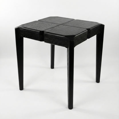 Black geometric stool or a side table on a white background
