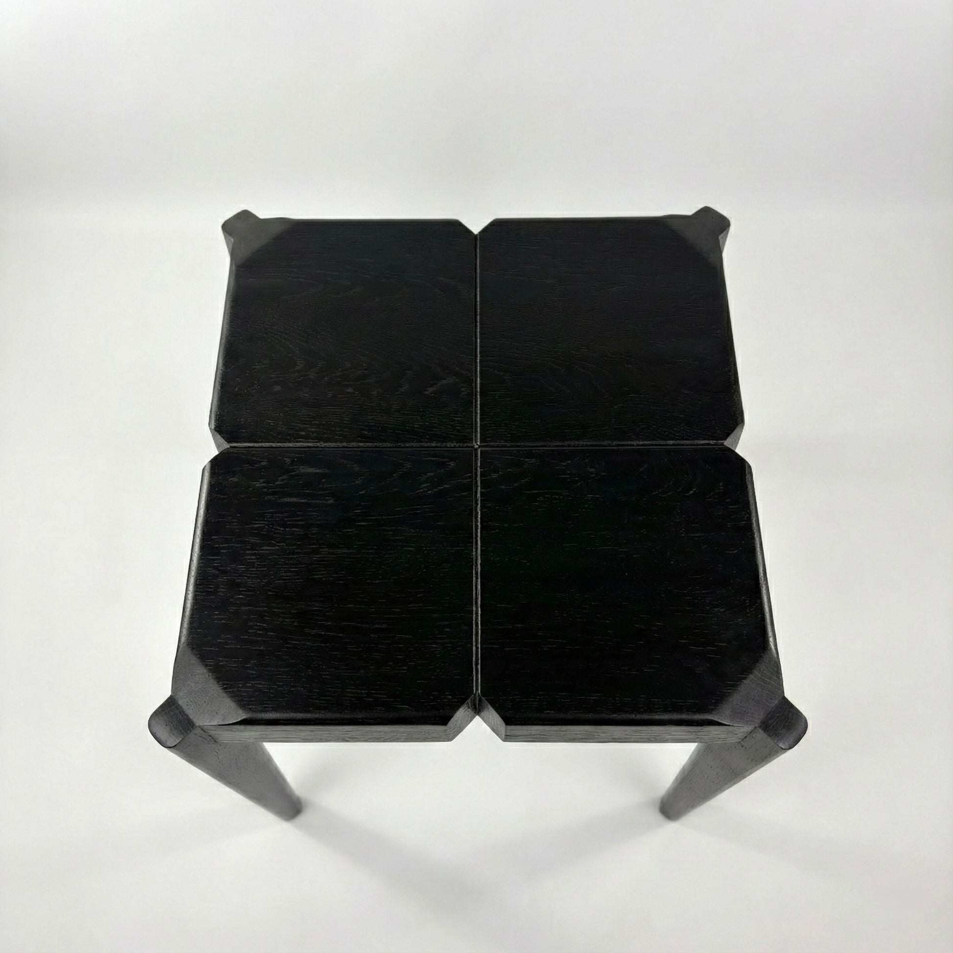 Black geometric stool on a white background