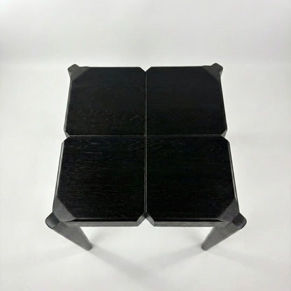 Black geometric stool on a white background